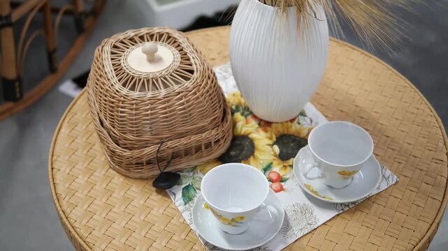Handcrafted charm shines in this close-up footage featuring a woven food box and ceramic tea set displayed on a textured wooden surface