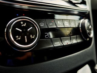 Car's climate control system is shown with the temperature set at 20 degrees