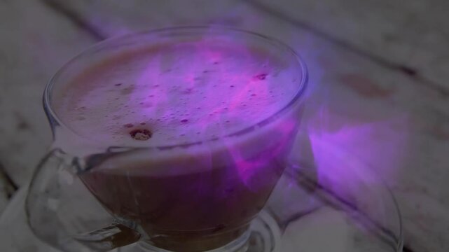 At start purple haze forming, pulsing and drifting around glass cup creating magical ambiance
