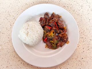 Black Pepper Beef with Steamed Rice on White Plate