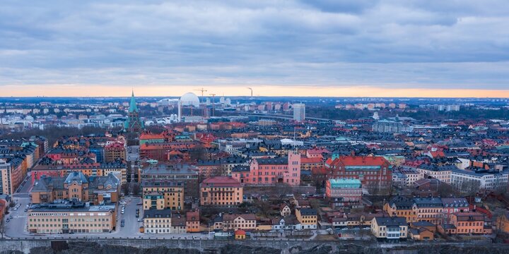 Aerial view of Stockholm reveals a tapestry of colorful buildings beneath a sky tinged with dawn's soft light, punctuated by the distinctive Kakn&Atilde;&curren;stornet, Stockholm, Stockholm County, Sweden.