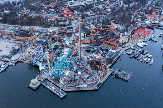 Aerial view of GrÃ¶na Lund amusement park with its vibrant rides contrasting against the calm waters of the Baltic Sea, Stockholm, Stockholm County, Sweden.