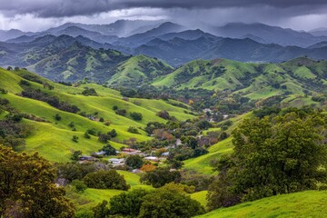 Verdant valley nestled in rolling hills beneath a stormy sky