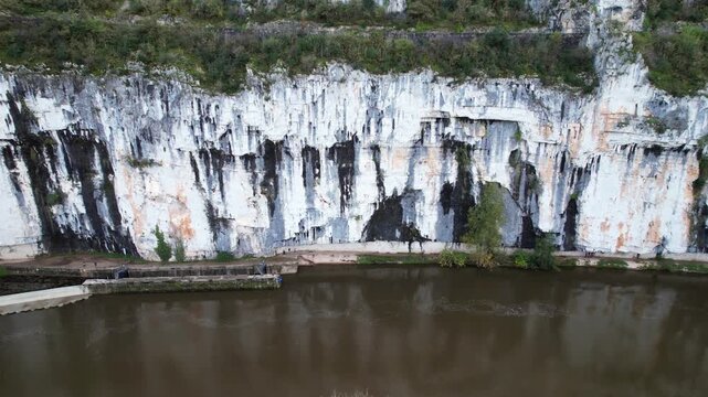 Towpath carved in rock by river, tranquil scene with historical roots