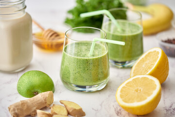 Healthy breakfast drinks, Kale and apple juice with honey and lemon.