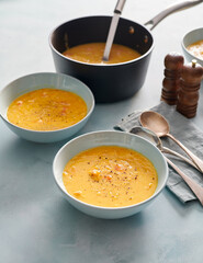 Delicious homemade lentil soup in two light blue bowls on a table.