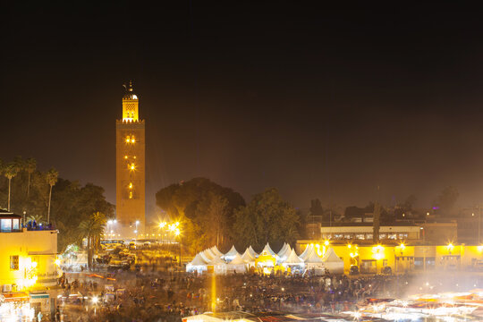 Jemaa el fnaa square in Marrakech Morocco at night, long exposure with crowds of people appearing blurred with motion. 