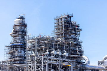Oil and Gas refinery petrochemical plant industrial on blue sky background, Oil and Gas refinery petrochemical plant pipeline steel, Oil and Gas refinery factory maintenance, Global energy refinery.