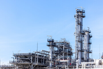 Oil and Gas refinery petrochemical plant industrial on blue sky background, Oil and Gas refinery petrochemical plant pipeline steel, Oil and Gas refinery factory maintenance, Global energy refinery.