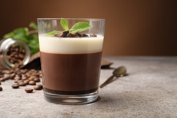 Delicious coffee panna cotta, beans and mint on grey table, closeup. Space for text