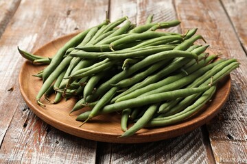 Fresh pea pods on color wooden table, closeup