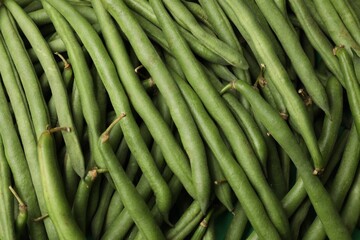 Fresh pea pods as background, top view