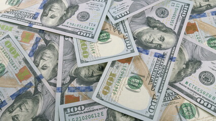 A CloseUp View of Scattered Dollar Bills on a Surface, Showcasing Different Denominations and Sides