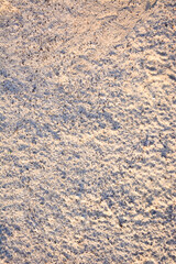 texture of sand. Grainy surface with subtle shadows and highlights. Natural beauty and intricate details of the sand. Backgrounds for design projects with a natural or coastal theme