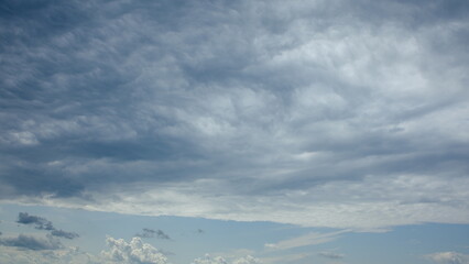 The strikingly dramatic cloudscape overhead creates a mesmerizing view that captivates the eye