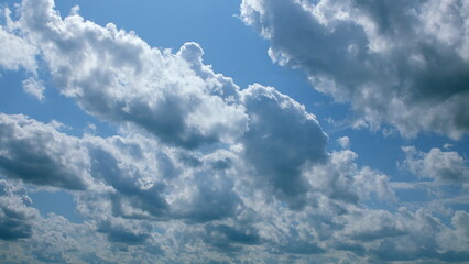 The scene presents majestic cloudscapes gracefully floating under a beautifully clear sky