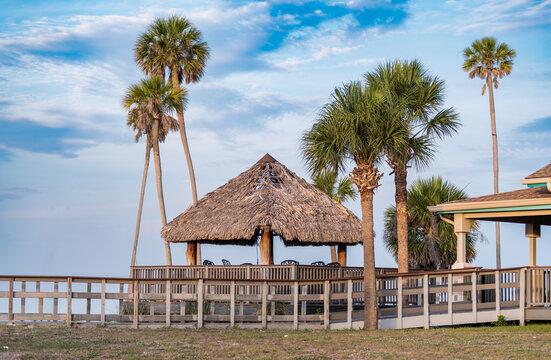 Tiki bar with a thatched roof, by the beach
