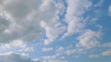 A beautifully serene and dreamy cloudy sky with a vibrant blue background and light