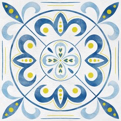 Decorative azulejo tile with a circular blue and yellow floral pattern on a white background