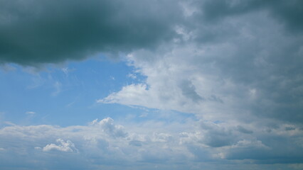 A breathtaking dynamic cloudy sky features an overcast backdrop adorned with stunning blue patches