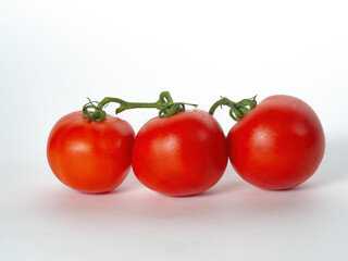 Three tomatoes on a white background
