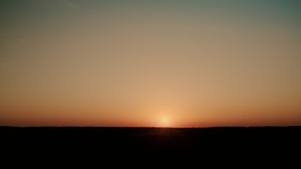 A Beautiful Sunset Over a Tranquil Horizon Captured in a Stunning Photograph of the Scene