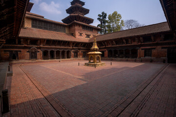 Old courtyard of Patan Durbar Palace as a peaceful place in Kathmandu, Nepal.