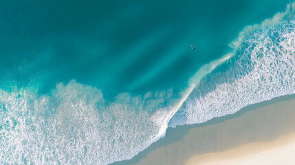 Aerial view of a turquoise coastline with abstract wave patterns and blue tones