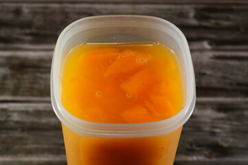 fresh mango Juice with pieces of mango fruit, Mangoes, mango is an edible stone fruit produced by the tropical tree Mangifera indica, Fresh Juice summertime and holiday concept