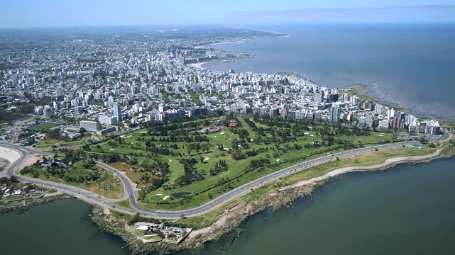 Aerial view of buildings near the coast, golf course and roads, presenting a blend of urban and recreational spaces, Montevideo, Montevideo, Uruguay.
