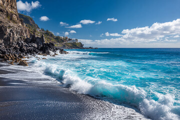 Shimmering turquoise waves crashing onto black volcanic sand beach, sea spray catching sunlight