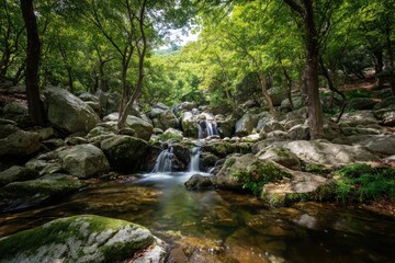 Fototapeta premium Tranquil waterfall cascading through a lush, rocky forest