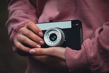 girl holding an old film camera