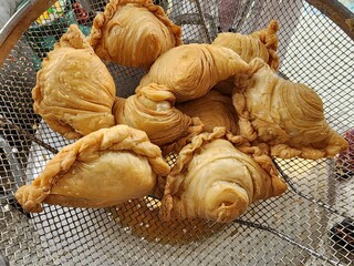 Curry Puff is a Western-Indian dish made from wheat flour wrapped around a curry powder filling, pleated like a cockle, and deep-fried. There are many fillings.
