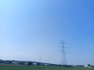 The image shows a clear blue sky with some scattered white and gray clouds near the horizon.