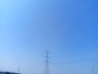 The image shows a clear blue sky with some scattered white and gray clouds near the horizon.