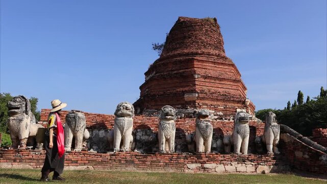 Footage of Female Visitor admiring the Ancient Pagoda Ruins of Wat Thammikarat Buddhist Temple, Ayutthaya Historical Park, Thailand