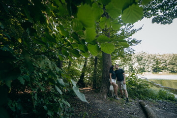 Obraz premium Adult couple relax at nature near lake at summer