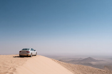 White car sand dune desert panoramic landscape blue sky adventure travel solitude peaceful scene