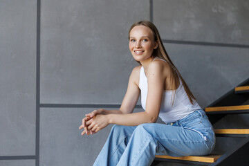 Obraz premium Shot of an attractive young woman sitting on the stairs while home alone