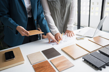 Interior designers brainstorming creative design ideas for modern home in collaborative meetingใ