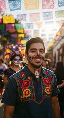 Joyful portrait of a handsome Latino man with skeleton face paint and embroidered shirt at a street festival for the traditional celebration of ancestors.