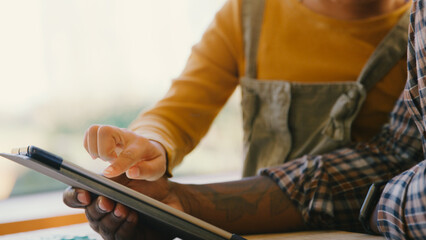 Close Up Of Father At Home With Daughter In Lounge Playing Game On Digital Tablet Together
