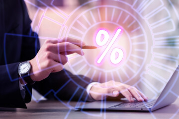 Man touching percent sign on virtual screen while using laptop at table, closeup