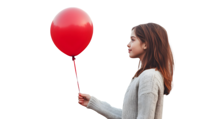 A young woman in a sweater holding a red balloon against a black background side profile view outdoors