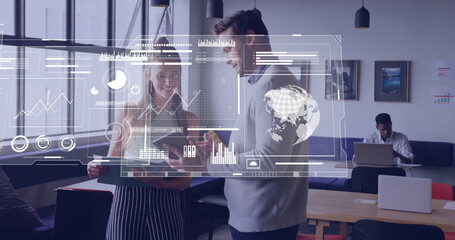 Discussing project two coworkers examining tablet with stylus in modern office, with data overlays