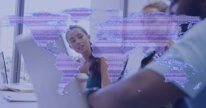 Collaborating professionals analyzing strategy in office meeting room, with laptops and map overlay