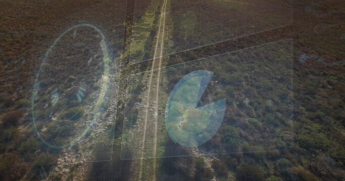 Displaying aerial view of dirt road running through rural scrubland, with translucent HUD overlays - Powered by Adobe