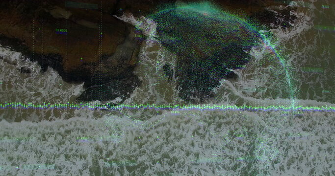 Fototapeta Merging blue circular overlay intersecting rocky shoreline, with waveform, data labels and sea foam