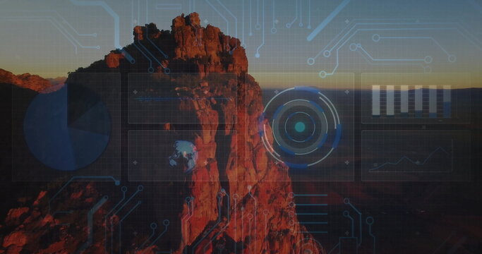 Fototapeta Glowing red sandstone pinnacle rising on canyon plateau at dusk, with grid and radar chart overlays